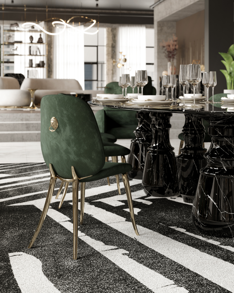 A green modern dining chair with the leon symbol in the back of the chair and gold details.