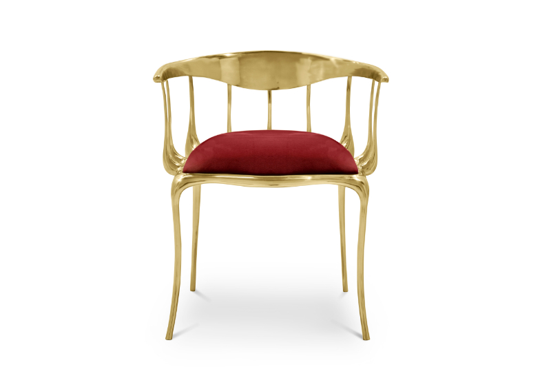 modern dining chair in a burgundy colour with gold details.
